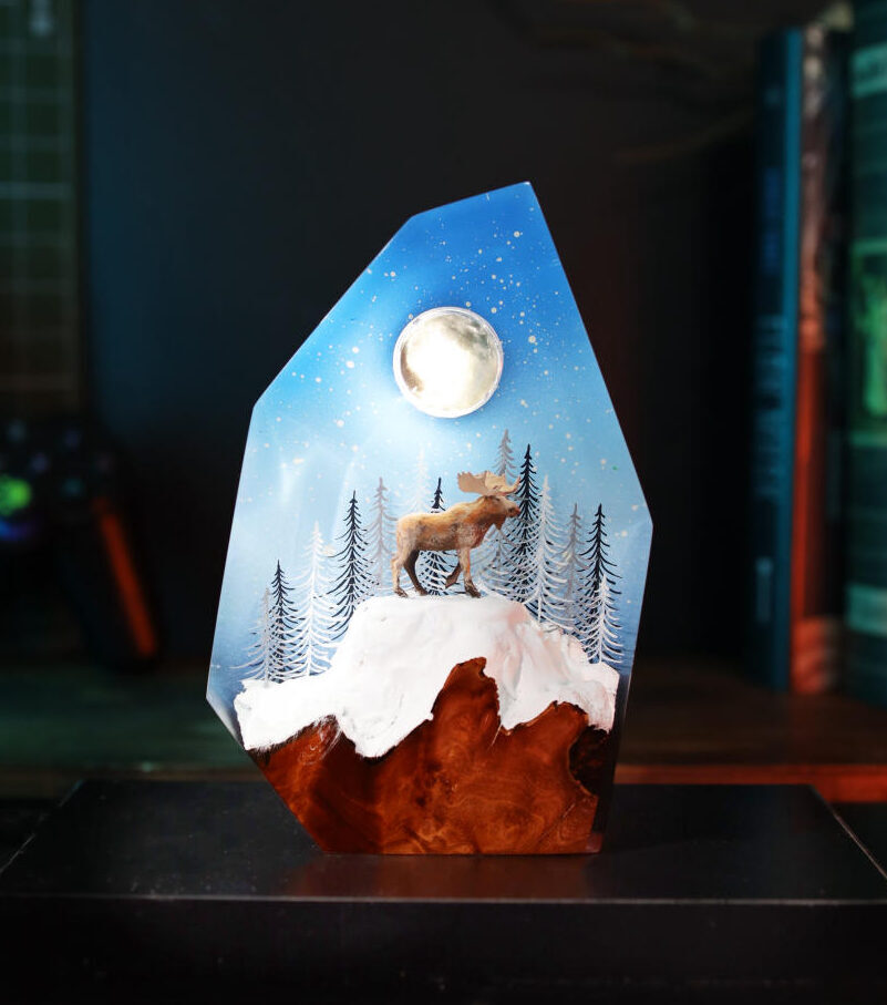 Reindeer in a winter forest lamp